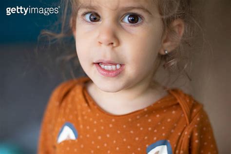 Portrait Of Cute Baby Girl Smiling In Bed And Having Fun Alone