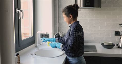 Indian Housewife Doing Housework Washing Bath Towels In Laundry Room