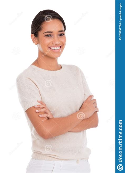 Shes Young And Confident Portrait Of A Beautiful Young Woman Standing With Her Arms Folded