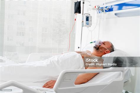 In The Hospital Sick Male Patient Sleeps On The Bed Stock Photo