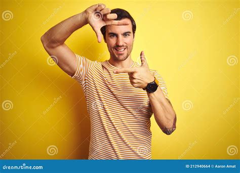 Young Handsome Man With Tattoo Wearing Striped T Shirt Over Isolated