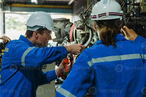 Teamwork Of Male Engineers Checking And Maintaining The Quality Of The