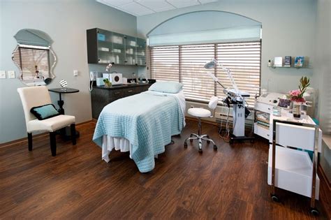 A Hospital Room With A Bed Desk And Chair In Its Center Area