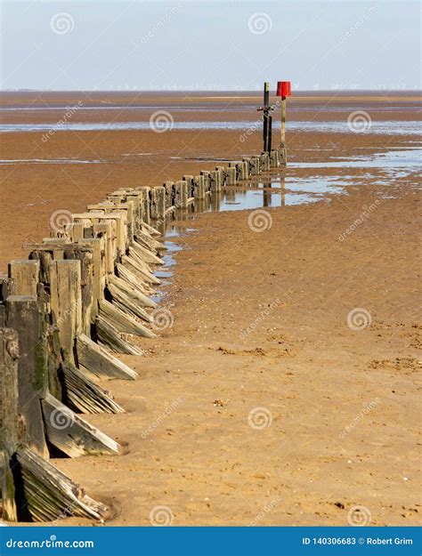 Wooden Groyne On Cleethorpes Beach With Wind Turbines In The Distance