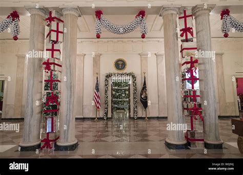 Holiday decorations are seen in the cross hall of the White House in ...