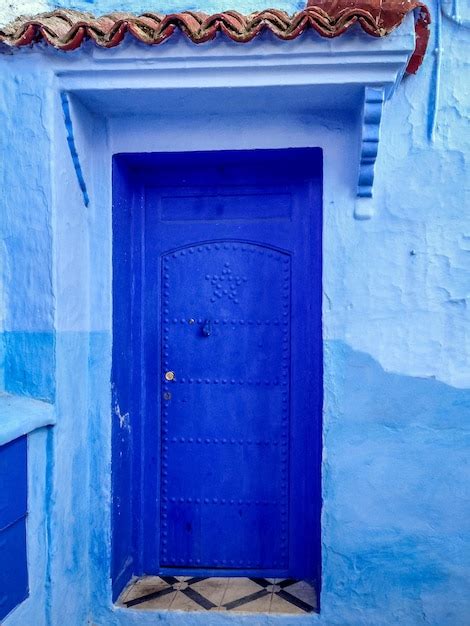 Premium Photo | Blue door in chefchaouen medina morocco