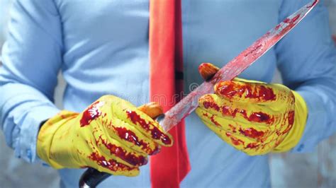 closeup male hands  rubber gloves holding  bloody knife stock image