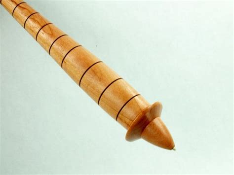 A Wooden Pen With Curved Ends On A White Background The Tip Is Made