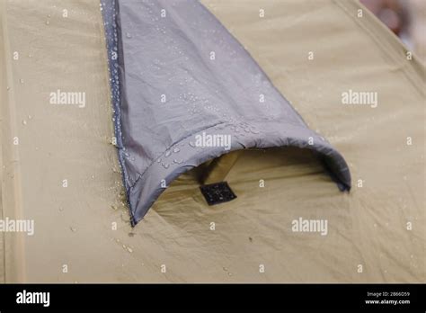 Close up of camping tent ventilation window detail with rain drops. Concept of waterproof cloth ...