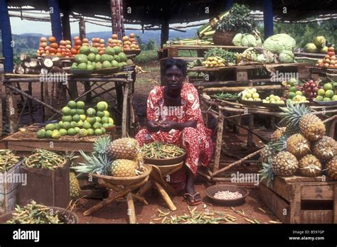 Black African Woman Sitting At Her Vegetable Market Stall Uganda Stock