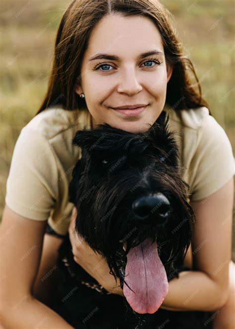 Premium Photo | Closeup portrait of a young woman hugging a big black