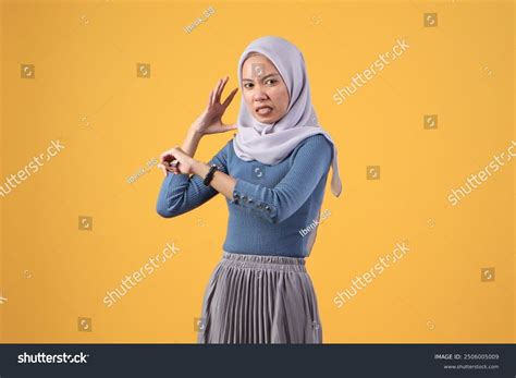 angry asian indonesian muslim woman wearing stock photo