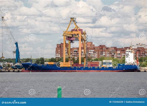 Container Crane Unloads Container Ship In Moby Dik Terminal Kronshtadt