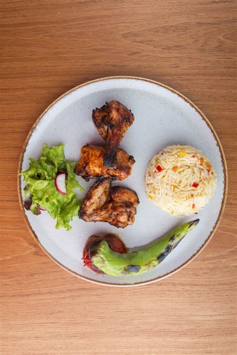 Chicken Kabab With Hot Pepper Rice Garnish And Tomato Salad Stock Image