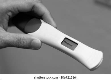 Womans Hand Holding Positive Pregnancy Test Stock Photo 1069215164