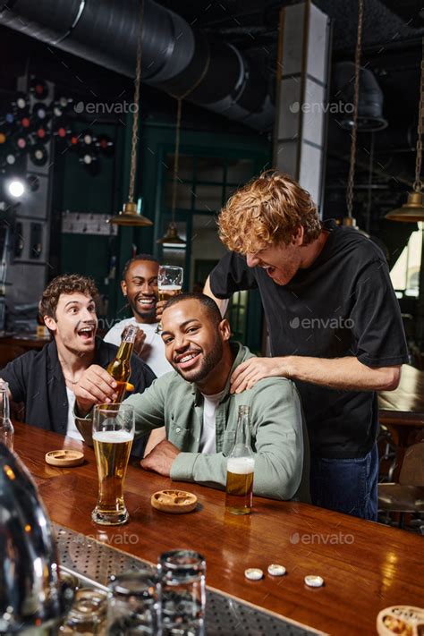 Redhead Man Touching Shoulders Of African American Groom During Bachelor Party Male Friendship