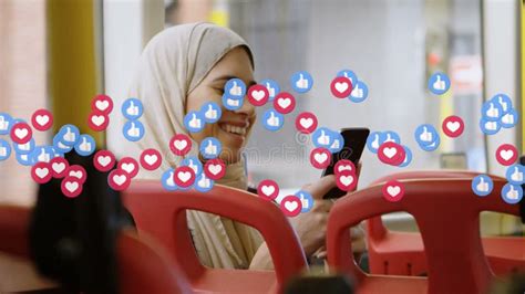 Animation Of Falling Social Media Icons And Emojis Over Woman In Hijab