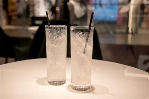 Premium Photo Two Empty Glasses From A Milkshake With Straws On A Table In A Cafe