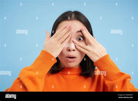 Close Up Portrait Of Korean Girl Waits For Surprise Shuts Her Eyes And