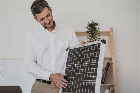 Businessman Examining Solar Panel At Desk Model Released Symbolfoto