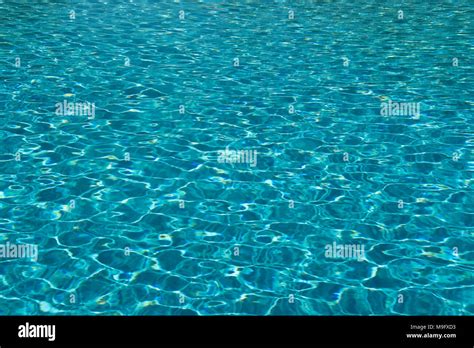 Clear Blue Water In The Swimming Pool On A Sunny Day With Ripples On