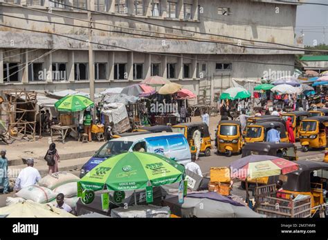 Busy Open Market At African Streets With Busy Traffic With Tuk Tuk Taxi