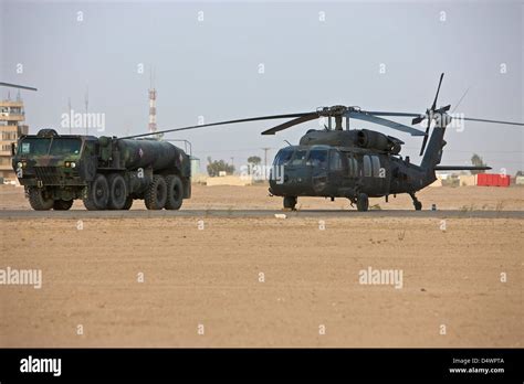 A U.S. Army UH-60 Black Hawk helicopter with its refueler truck at ...