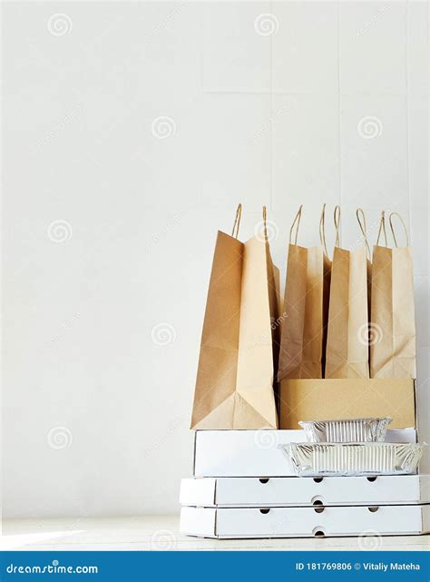 Takeaway Paper Bags And Carton Boxes On Table In White Bright Room