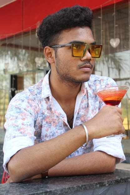 Premium Photo Portrait Of Young Man Drinking Glasses