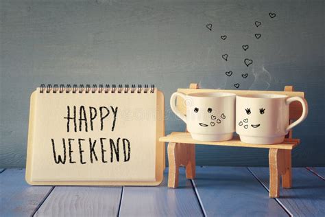 Coffee Cups Next To Notebook With Phrase Happy Weekend Stock Image