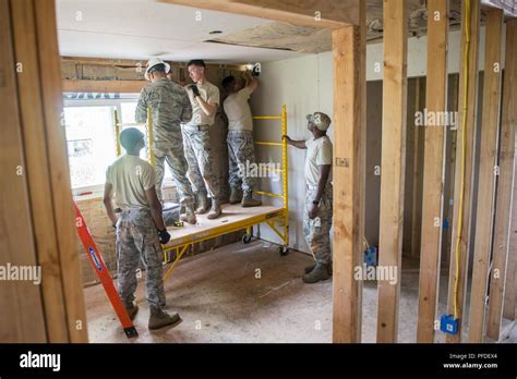 Members Of The 147th Civil Engineering Squadron Secure Drywall To The