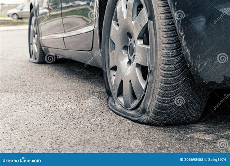 Flat Car Tire Close Up Punctured Wheel Stock Photo Image Of Rainy