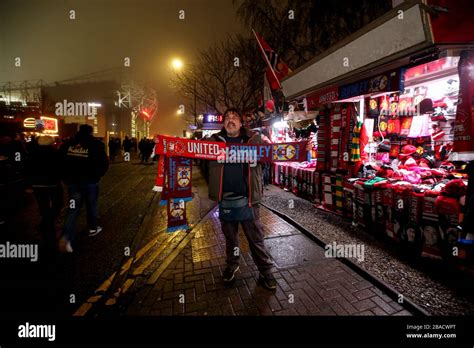 A Stall Holder Selling Half And Half Scarves Outside Of Old Trafford