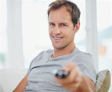 Parked In Front Of The Tv Portrait Of A Handsome Man Holding A Remote