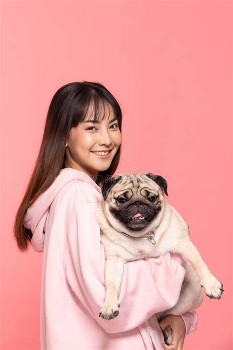 Beauty Asian Young Woman Holding Dog Pug Breed On Her Arm Smile And