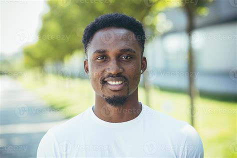 Portrait Of Young Millennial African American Man Looking At Camera