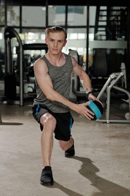 Premium Photo | Man with medicine ball doing lunges