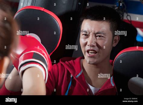 Boxing Couch Training With Female Student Holding Boxing Pads Stock