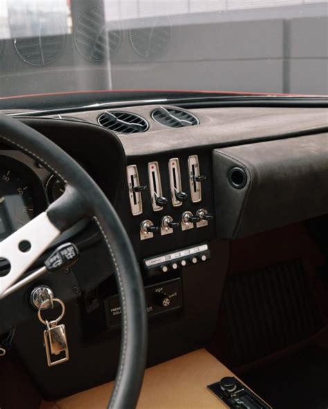 The Interior Of An Old Car With Leather Steering Wheel And Dash Board