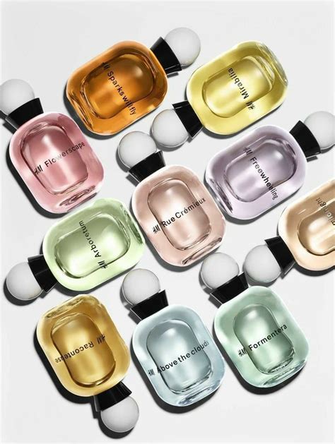 Nine Bottles Of Perfumes In Different Colors On A White Surface With