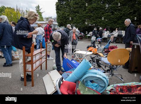 Jumble Sale People Searching Through Unwanted Donated Items And