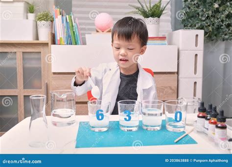 Little Asian Kindergarten Kid Studying Science Making Sugar Water