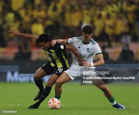 Romarinho Of Al Ittihad And Gabri Veiga Of Al Ahli Battling For The