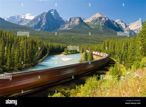 A Train Passes Through The Famous Morants Curve Near Lake Louise In