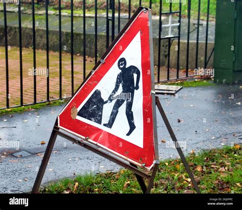 funny men at work road sign Stock Photo - Alamy