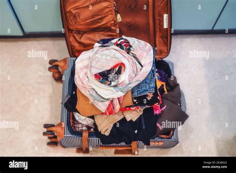 Open Suitcase Full Of Clothes In Room Stock Photo Alamy