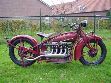 An Old Motorcycle Is Parked In The Grass