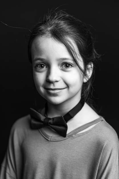 Premium Photo Portrait Of Girl Smiling Against Black Background