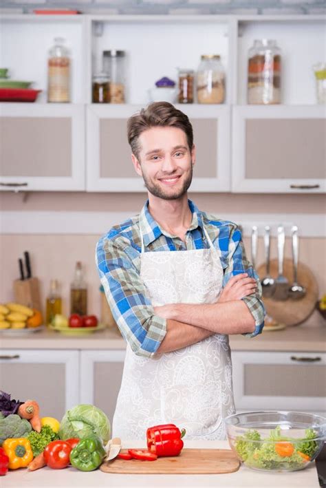 Smiling Man Cooking Dinner In Kitchen Stock Photo Image Of Passion