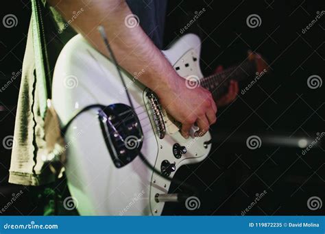 Detail Of Man Playing White Electric Guitar During A Indie Rock Concert